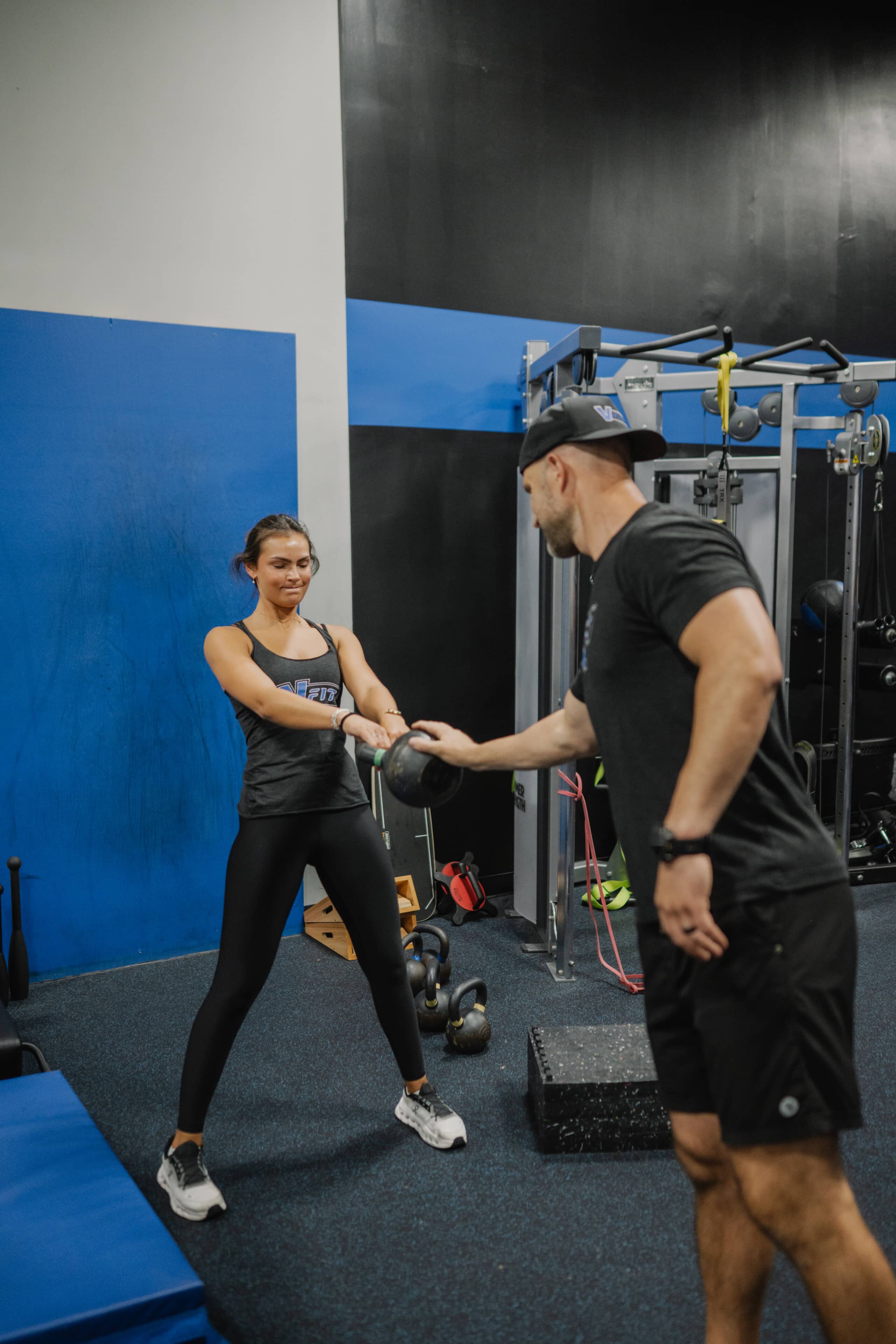 kettlebell swing exercise with trainer